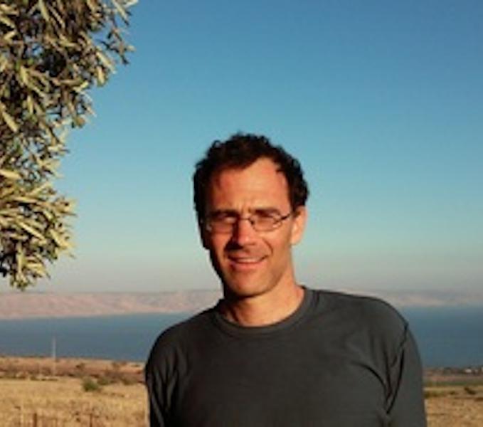 Eitan Shelef standing in front of outdoor landscape